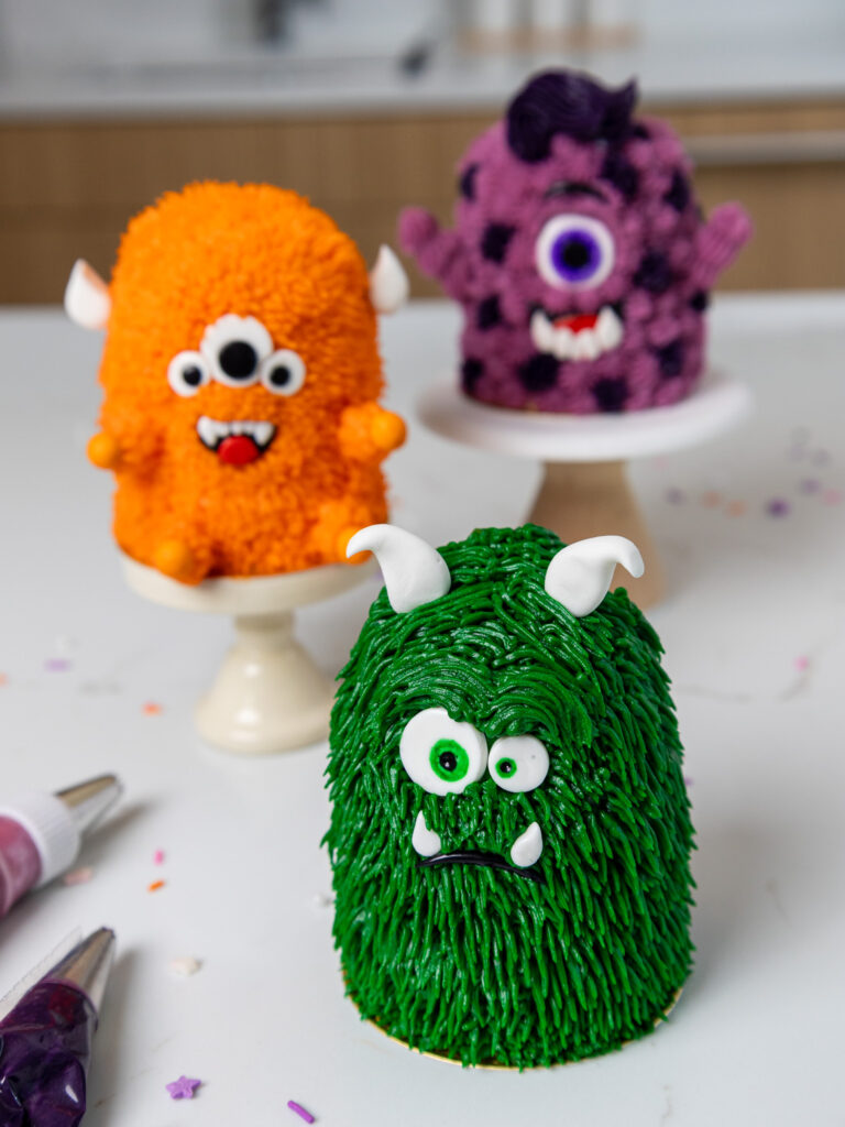 image of cute mini monster cakes made using stacked cupcakes and buttercream