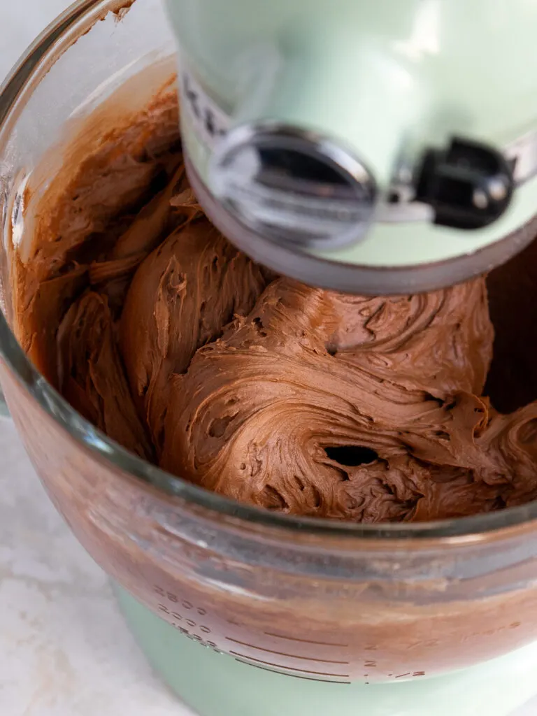 image of chocolate buttercream being mixed in a stand mixer