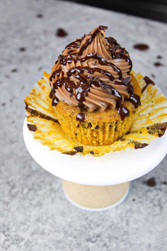 image of chocolate chip pumpkin cupcakes decorated with a chocolate drizzle