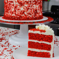image of sliced red velvet cake, decorated with cake crumbs