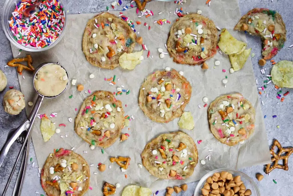 image of milk bar-inspired compost cookies from overhead, with ingredient scattered around them