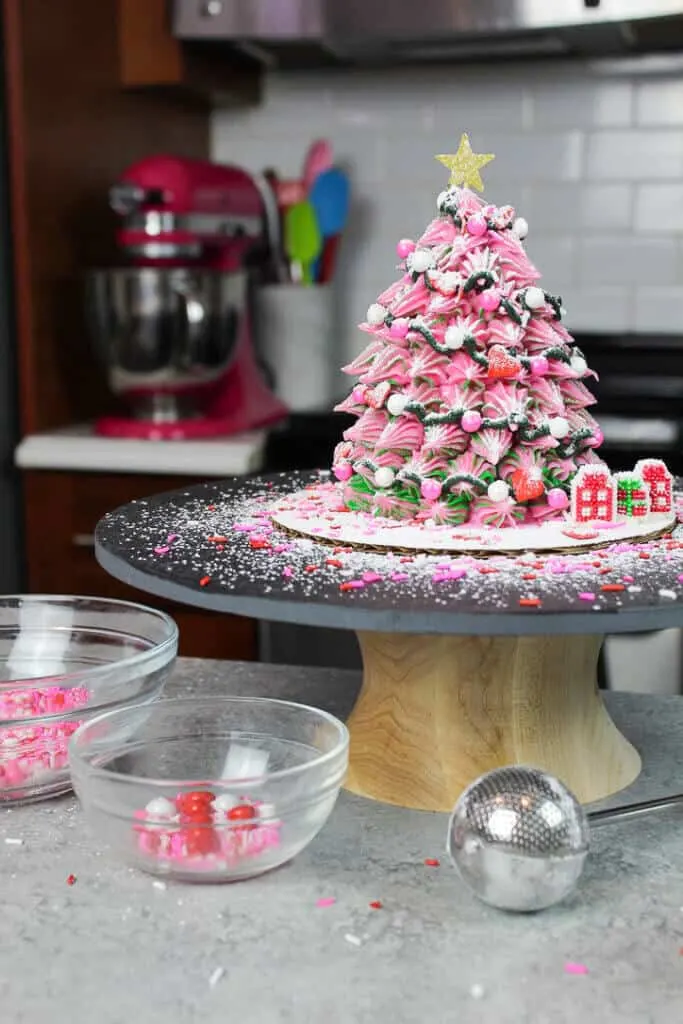 image of pink christmas tree cake dusted with powdered sugar snow