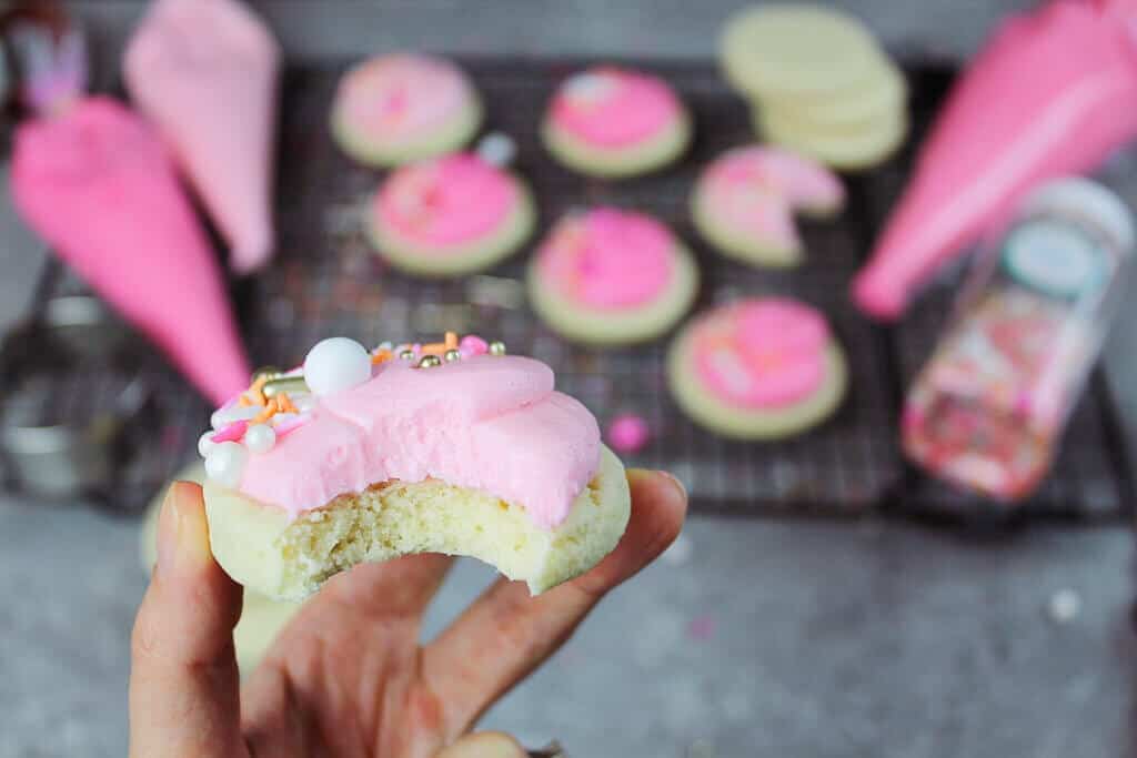 image of bitten into sugar cookie with buttercream frosting