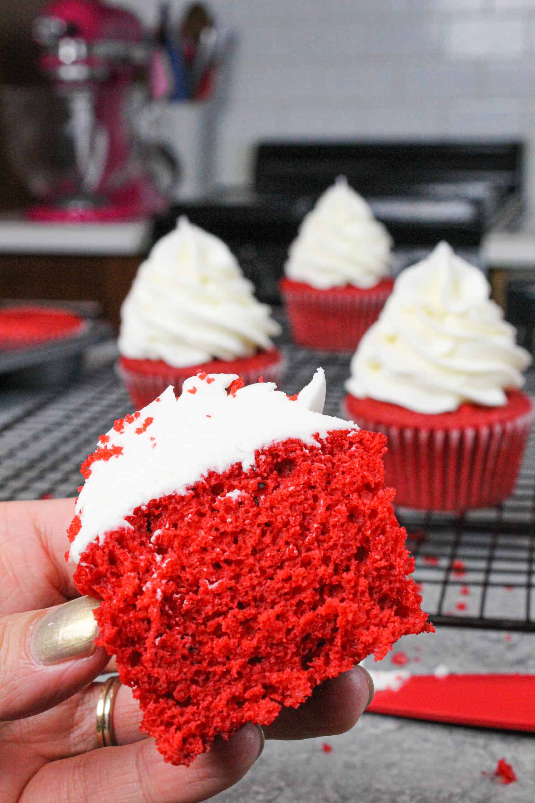 image of moist red velvet cupcake, cut in half to show moist crumb