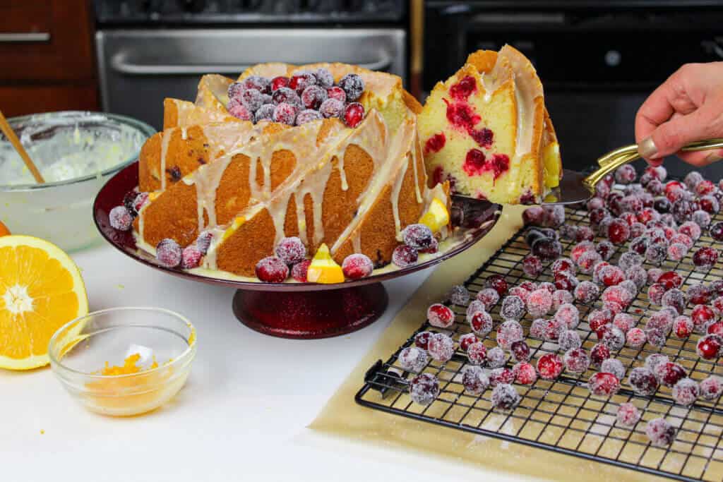 image of the best orange bundt cake with sugared cranberries
