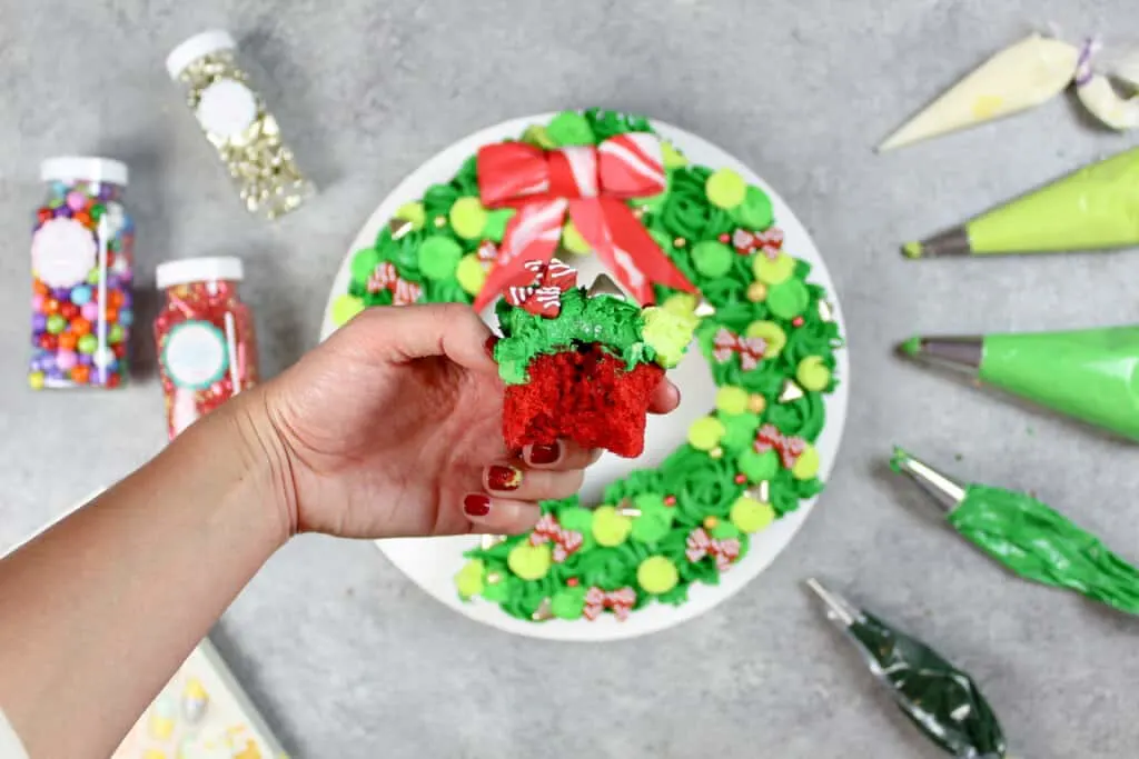 image of red velvet cupcake bitten into from a christmas cupcake wreath cake