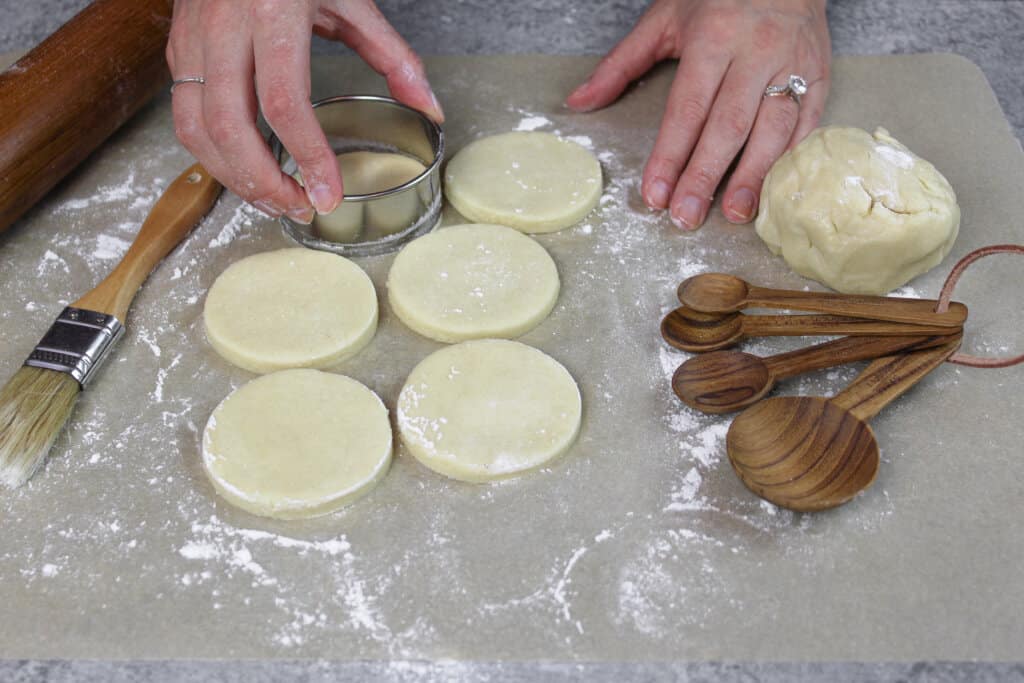 image of sugar cookies with cream cheese being cut out