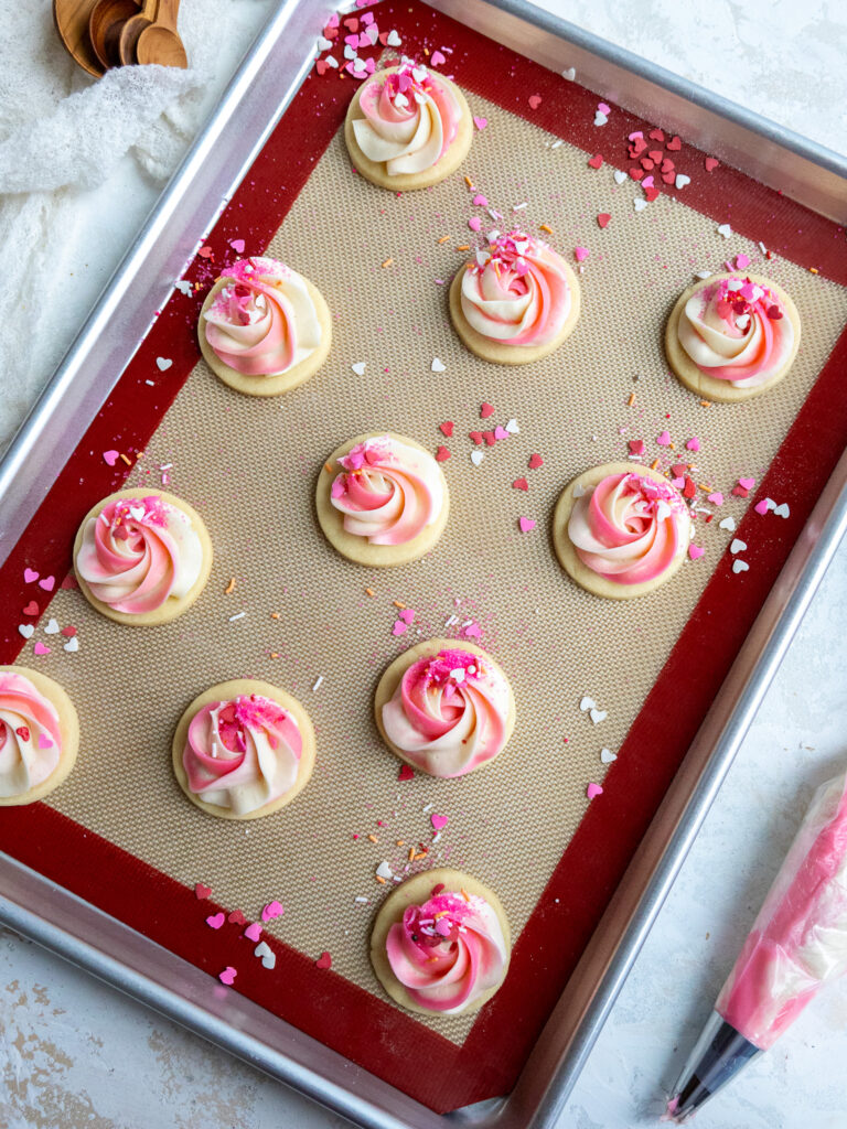 image of buttercream cookies that have been frosted with pink and white buttercream