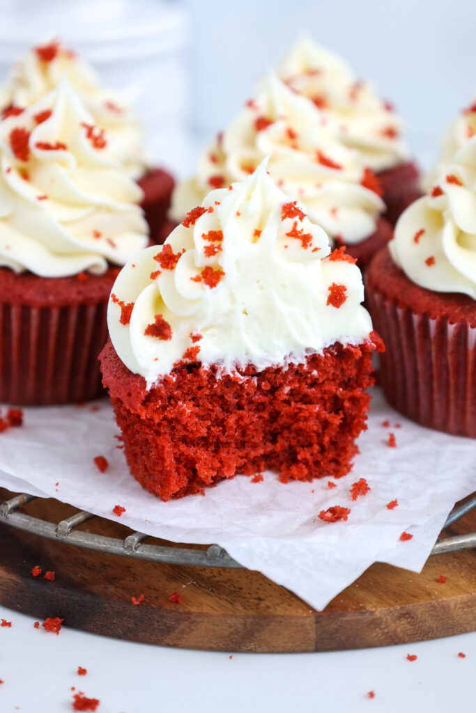 image of a red velvet cupcake that's been cut into to show how tender and soft it is