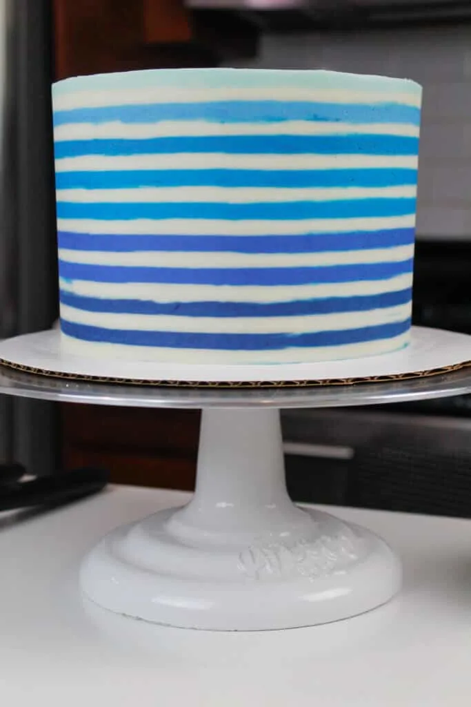 image of cake with blue horizontal buttercream stripes