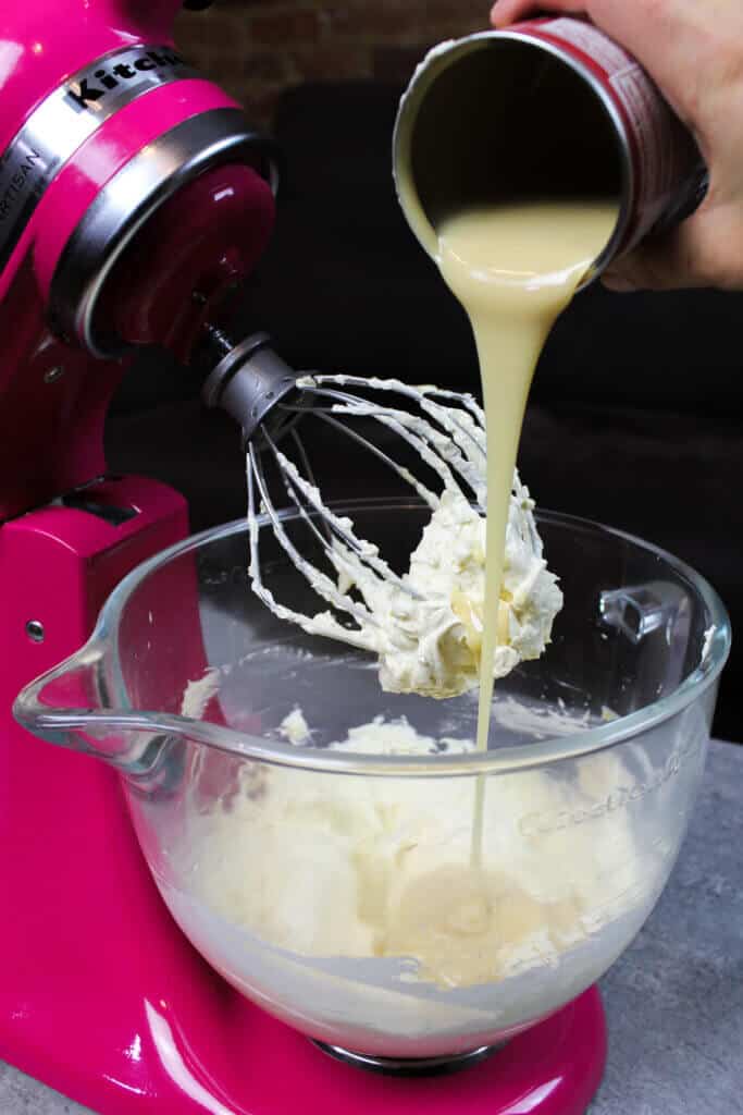 image of adding sweetened condensed milk into sweetened condensed milk frosting