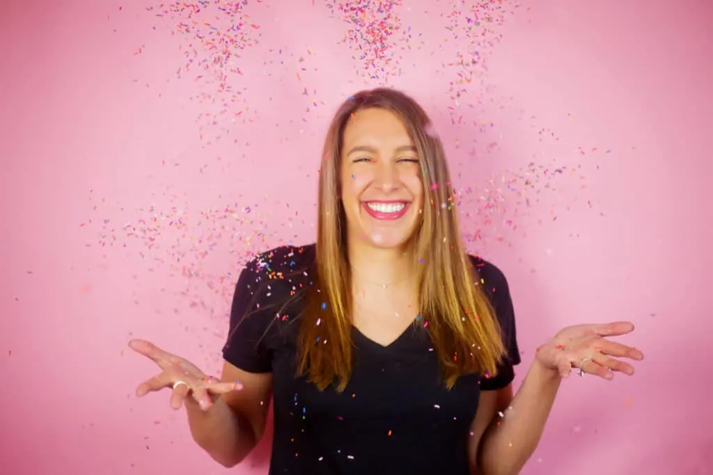 image of chelsey white of chelsweets, tossing sprinkles in the air