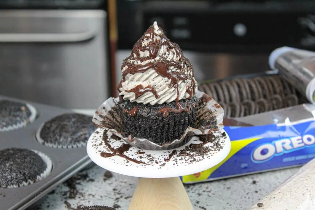 image of oreo cupcake decorated with chocolate ganache and crushed oreos