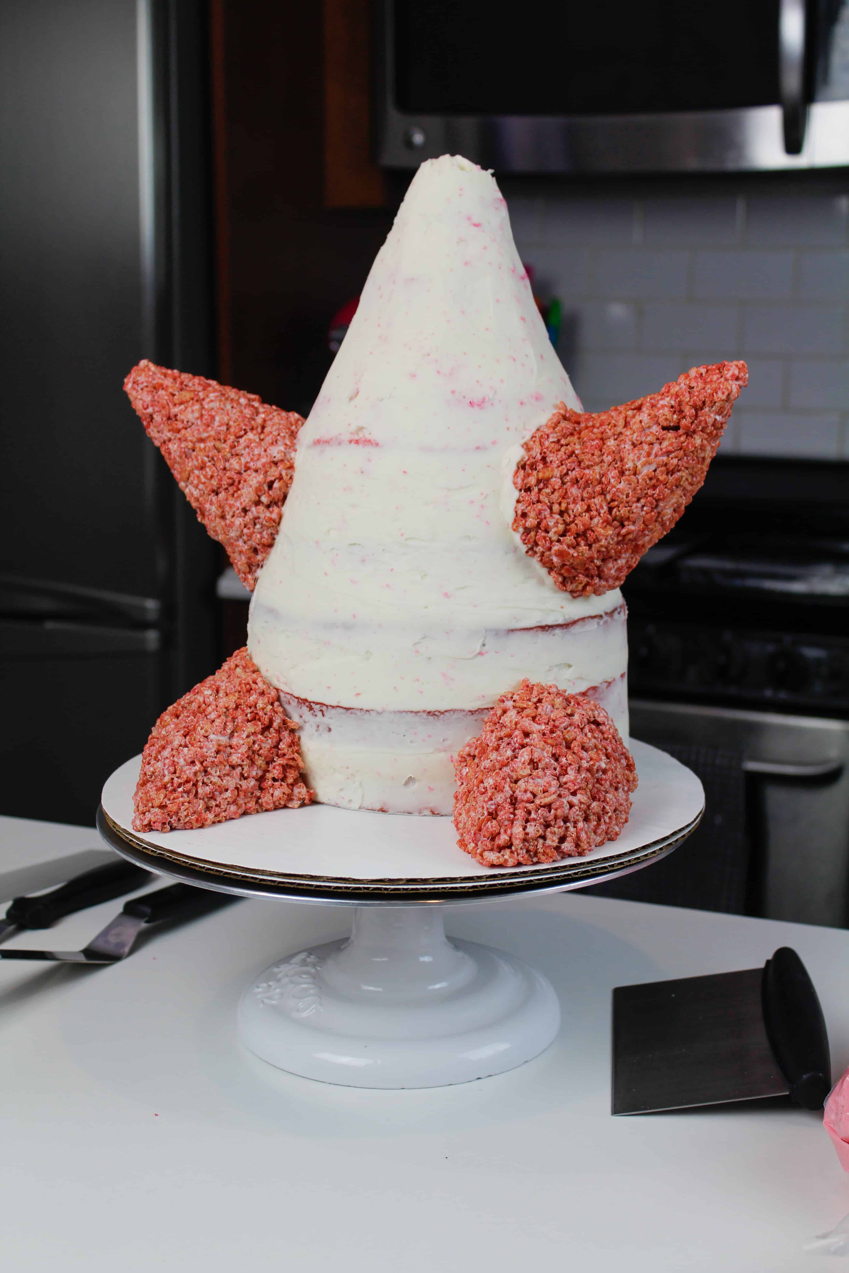 image of cake decorating rice krispies added to a patrick star cake to make his arms and legs