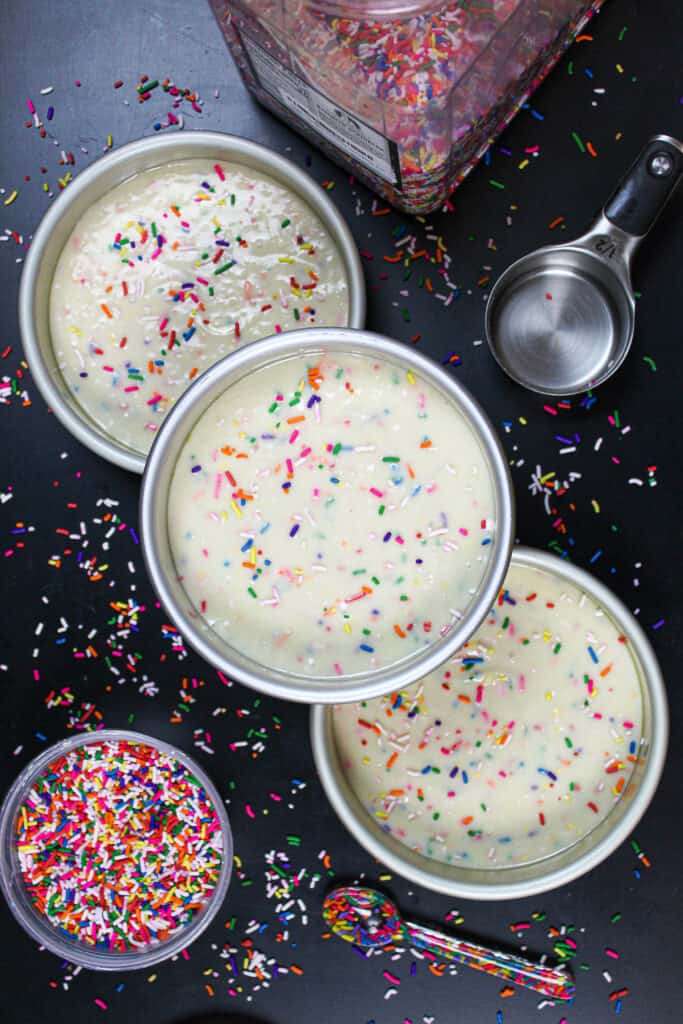 image of funfetti cake batter in 6 inch cake pans, ready to be baked
