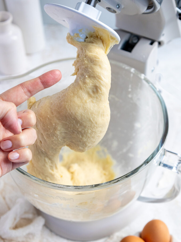 image of quick yeast dough being tested by poking it with a finger and seeing if it's tacky but not sticking to my finger