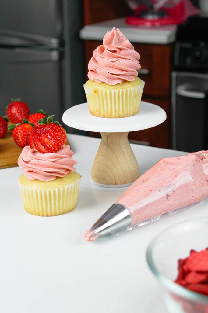 image of cupcakes with strawberry frosting piped on top