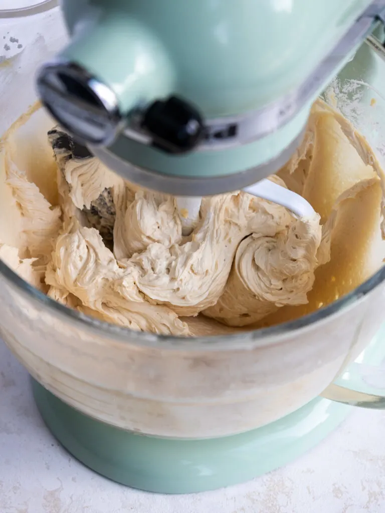 image of caramel buttercream being mixed in a kitchenaid mixer