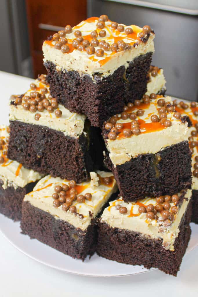 image of slices of caramel chocolate sheet cake, stacked on a plate