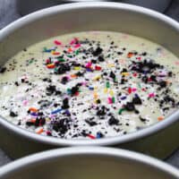 image of oreo funfetti cake batter in cake pans ready to be baked