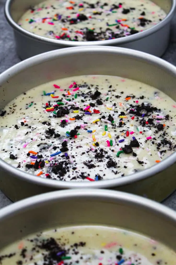 image of oreo funfetti cake batter in cake pans ready to be baked