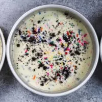 image of oreo funfetti cake layers in pans, ready to be baked in the oven