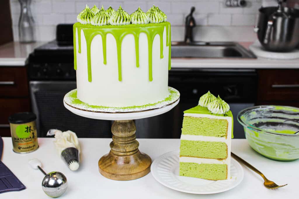 image of a matcha cake, with a slice placed on a plate to show how fluffy and delicious this matcha cake recipe is
