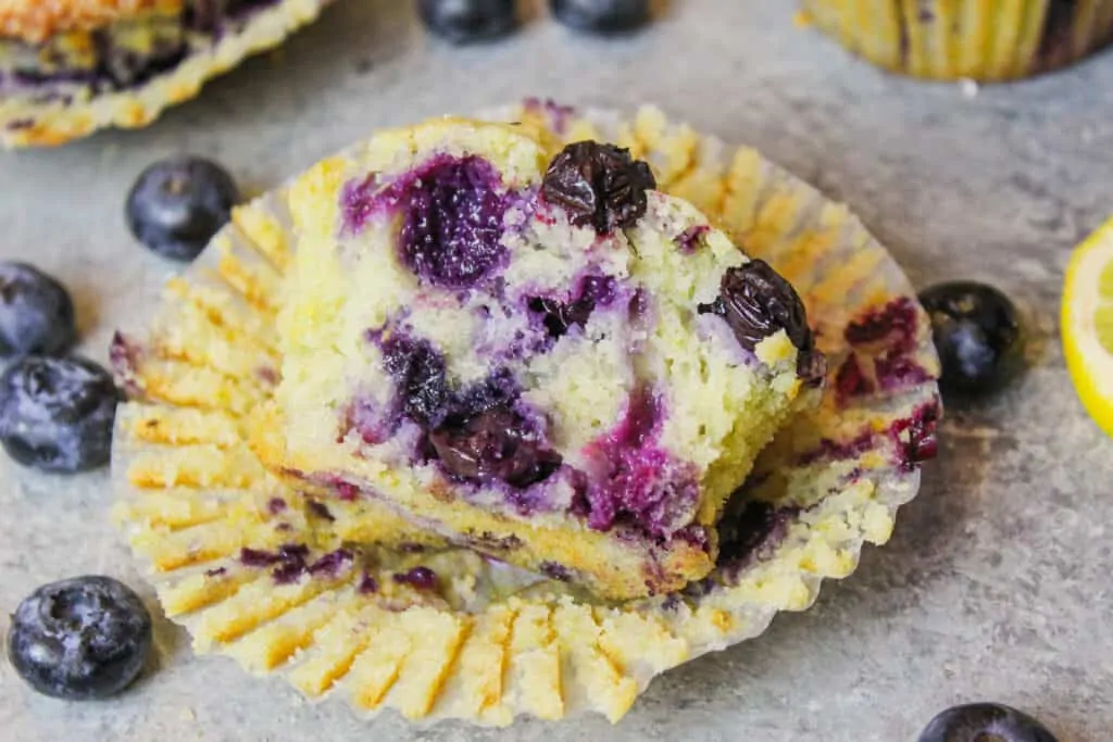 image of a small batch blueberry muffin as part of a berry recipe round up
