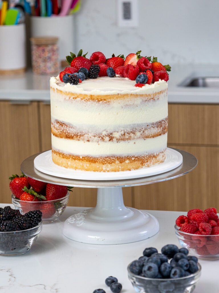 image of a berry chantilly cake that's been decorated with fresh berries