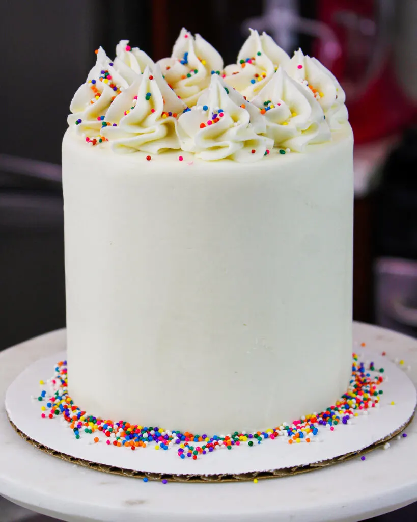 image of an adorable mini birthday cake decorated with sprinkles and buttercream frosting
