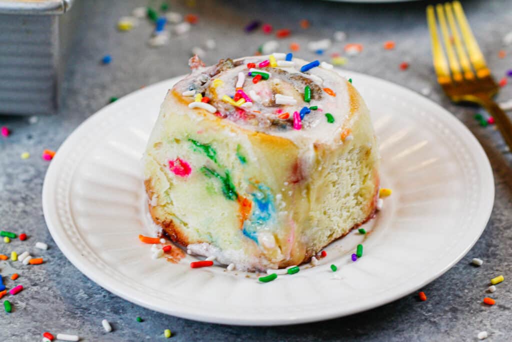 image of a funfetti cinnamon roll that is being shared as part of a cinnamon roll round up