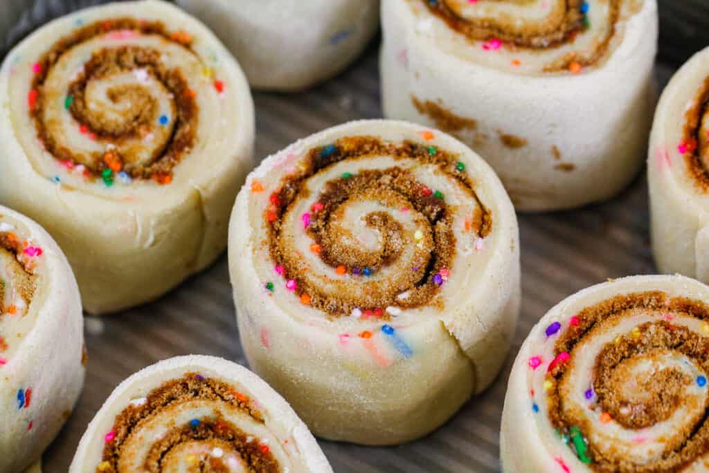 image of funfetti cinnamon rolls made with instant yeast that are proofed and ready to be baked in the oven