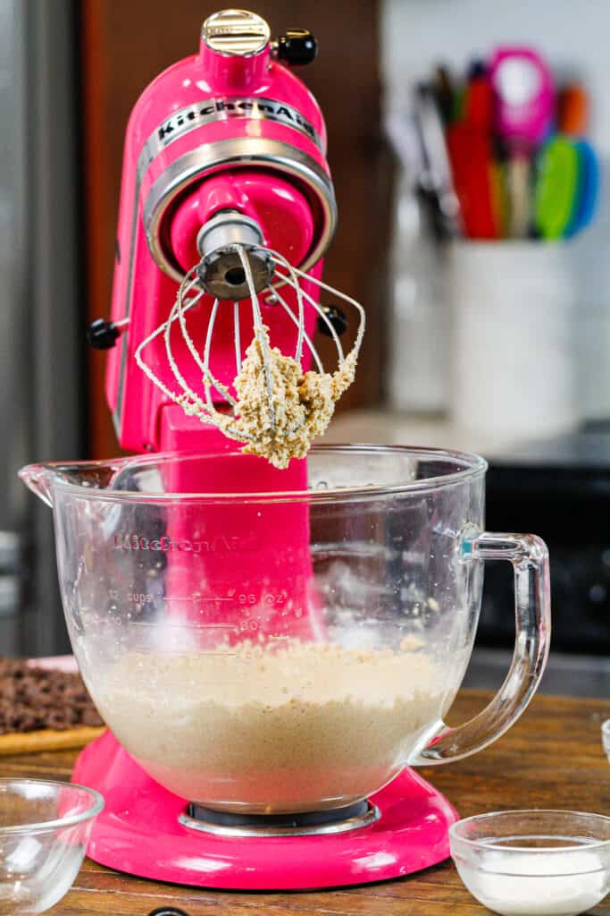 image of brown butter and brown sugar cream together in a pink kitchenaid stand mixer