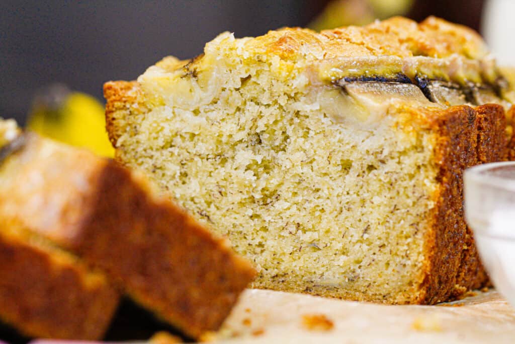 image of classic banana bread loaf sliced open to show the tender, fluffy texture of the loaf