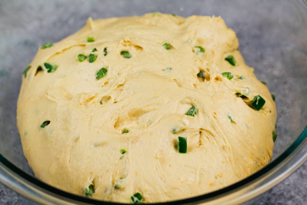 image of dough for jalapeno Cheddar Bagels in a bowl, rising before being rolled out in to bagels
