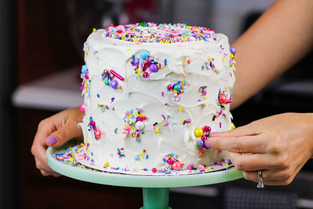 image of a funfetti marble cake deocrate with pretty sprinkles by chelsey white of chelsweets