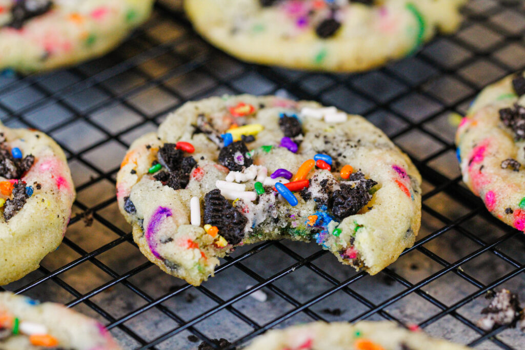 image of funfetti oreo cookie that's been bitten into to show how soft and chewy it is