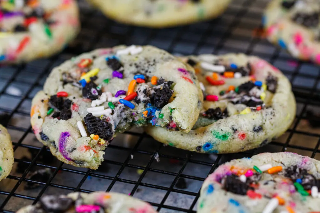 image of funfetti oreo cookies being eaten while they're still warm and fresh out of the oven
