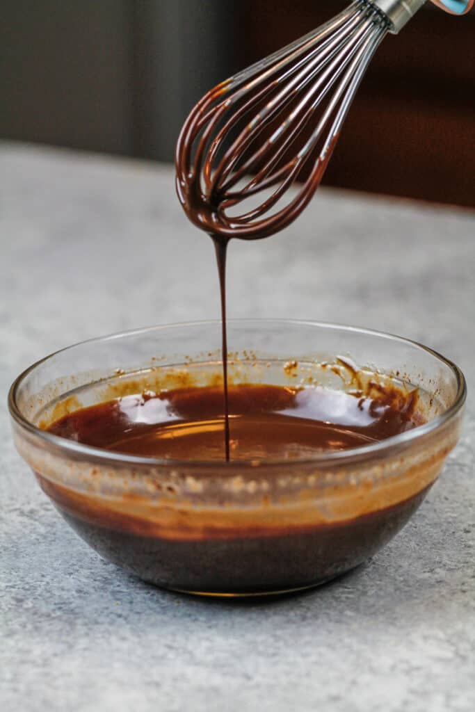 image of chocolate ganache ready to be swirled into marble cake layers