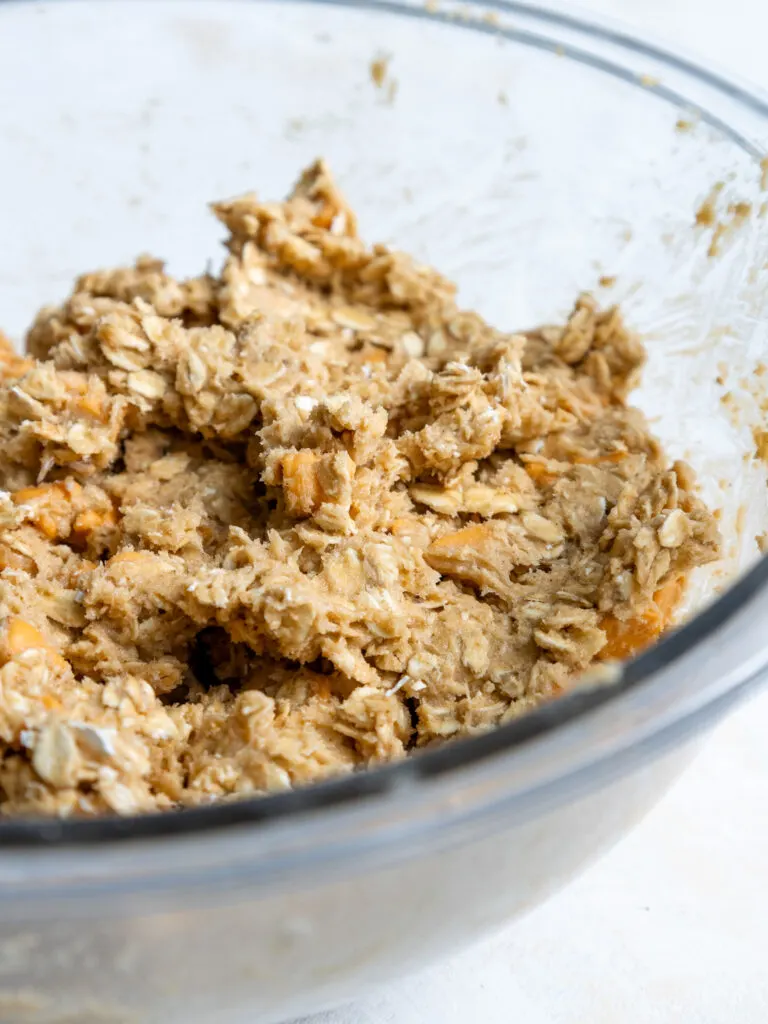 image of butterscotch oatmeal cookie dough that's been mixed in a glass bowl