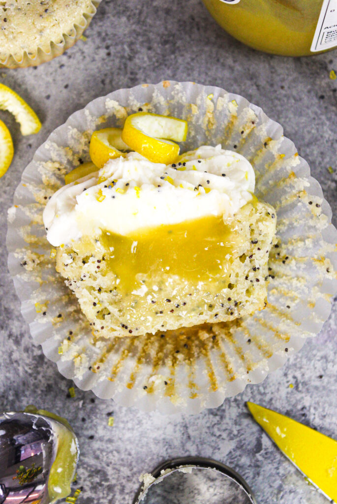 image of lemon poppy seed  cupcake cut in half to show lemon curd filling