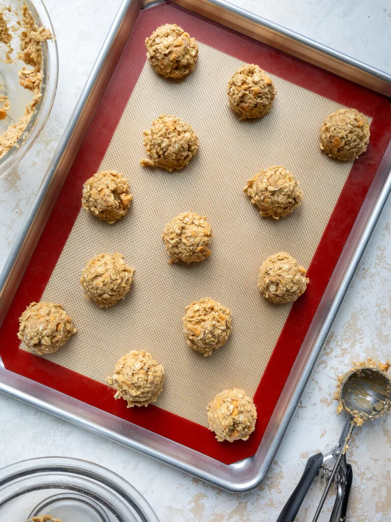 image of oatmeal scotchies scooped onto a pan to be chilled before being baked