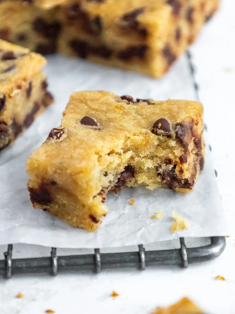 image of a banana chocolate chip bar that's been bitten into to show its tender and moist texture