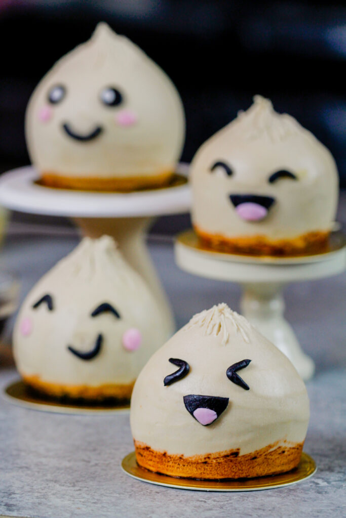image of dumpling cupcakes with one cut open to show the moist vanilla cupcake it's made with