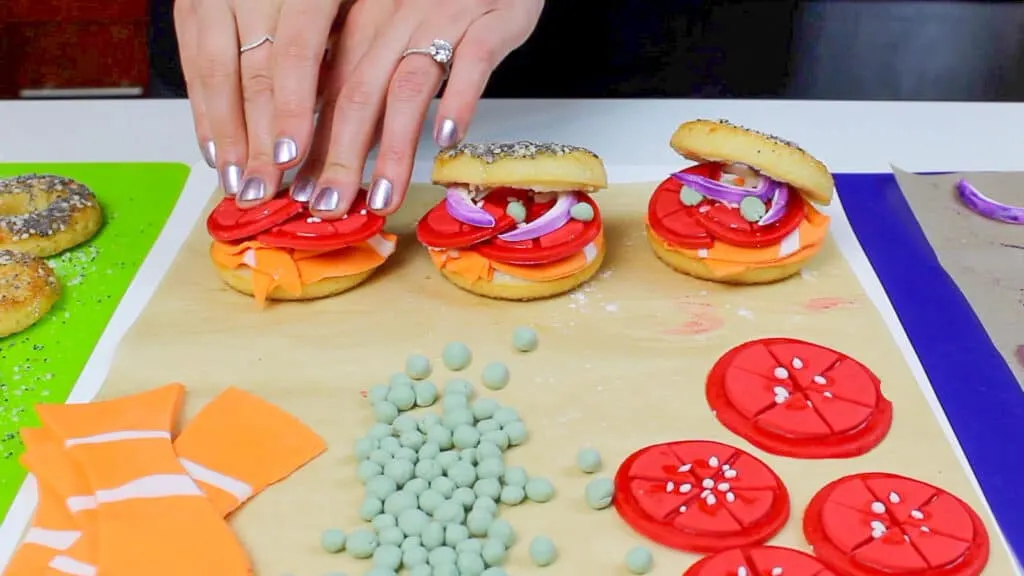 image of mini dessert bagels being made from baked donuts to decorate a bagel cake
