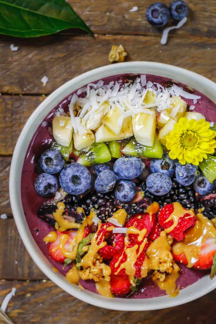 image of peanut butter acai bowl topped with fresh fruit and peanut butter
