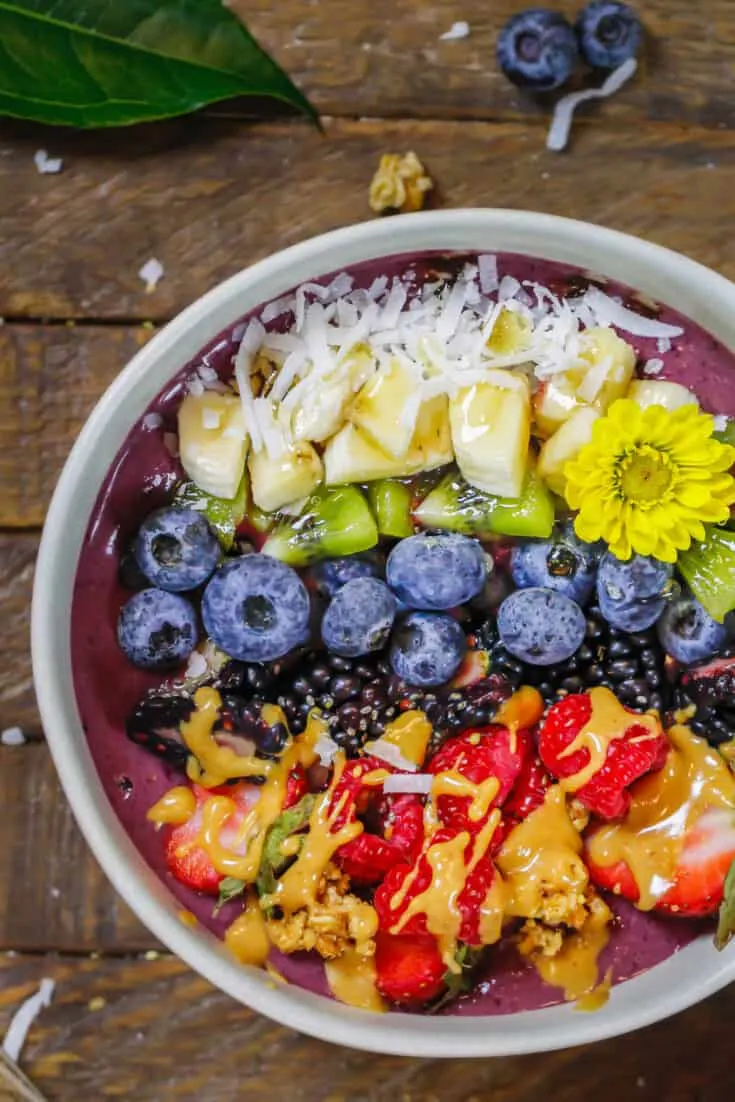 image of peanut butter acai bowl topped with fresh fruit and peanut butter