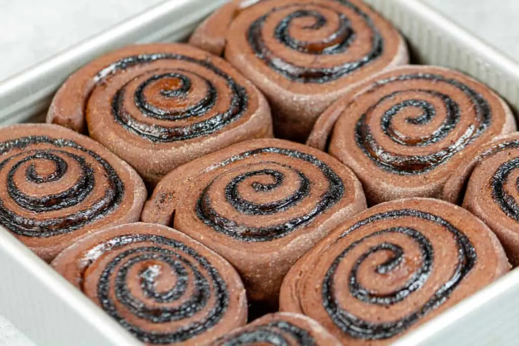 image of proofed chocolate cinnamon rolls ready to be baked