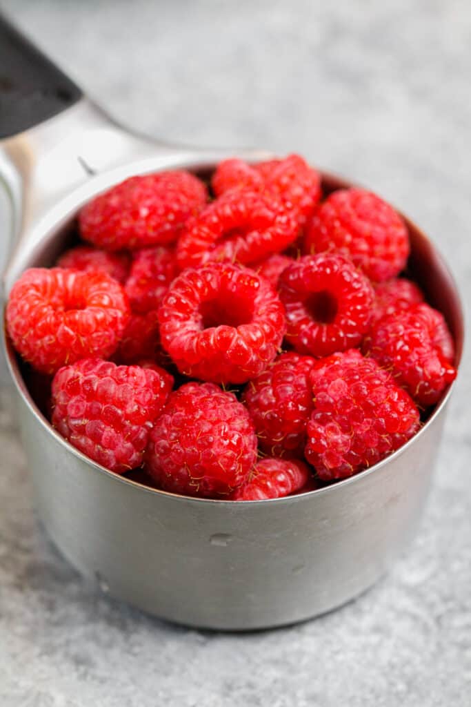 image of fresh raspberries in a measuring cup 