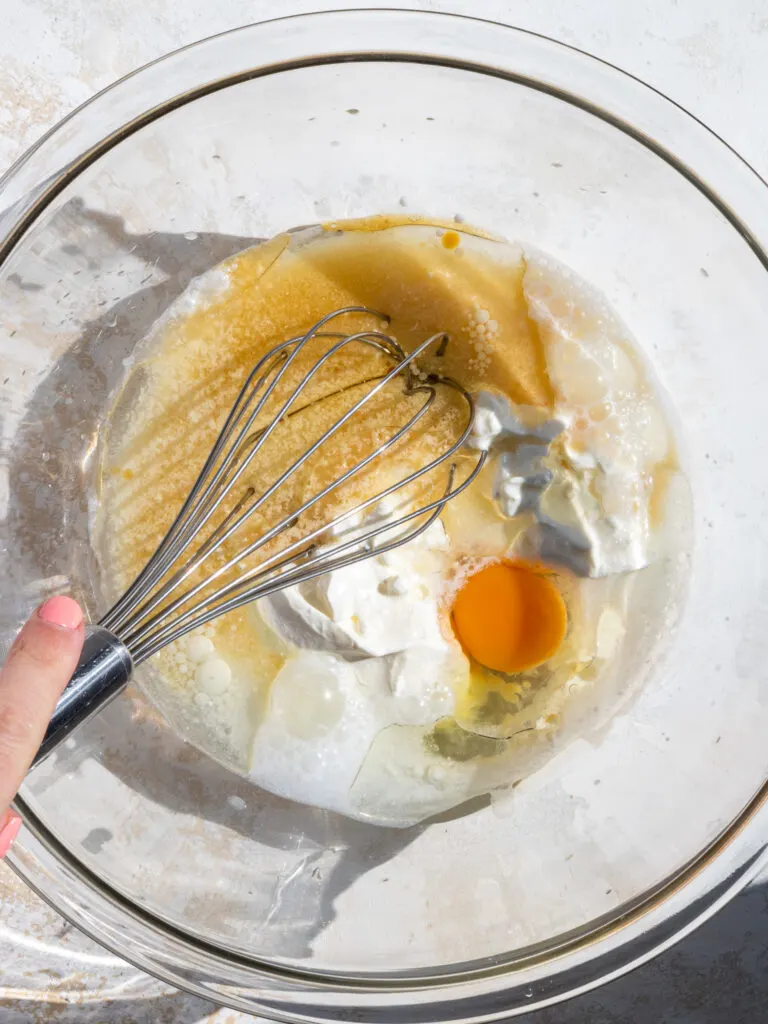 image of wet ingredients being mixed together with a whisk